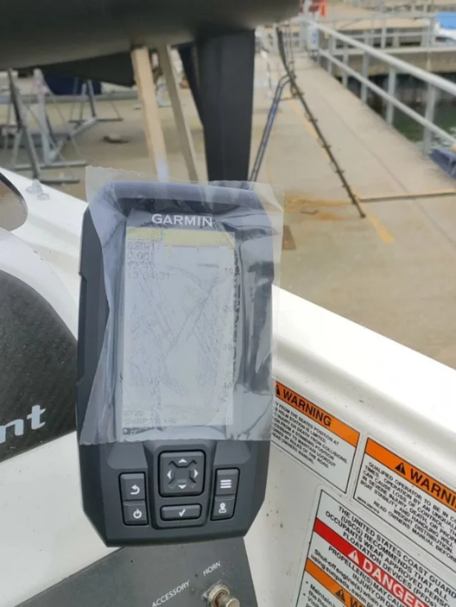 A Garmin GPS fish finder wired in and fitted to a helm console.