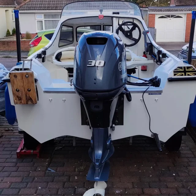 A brand new Yamaha F30BETL outboard installed on a transom.